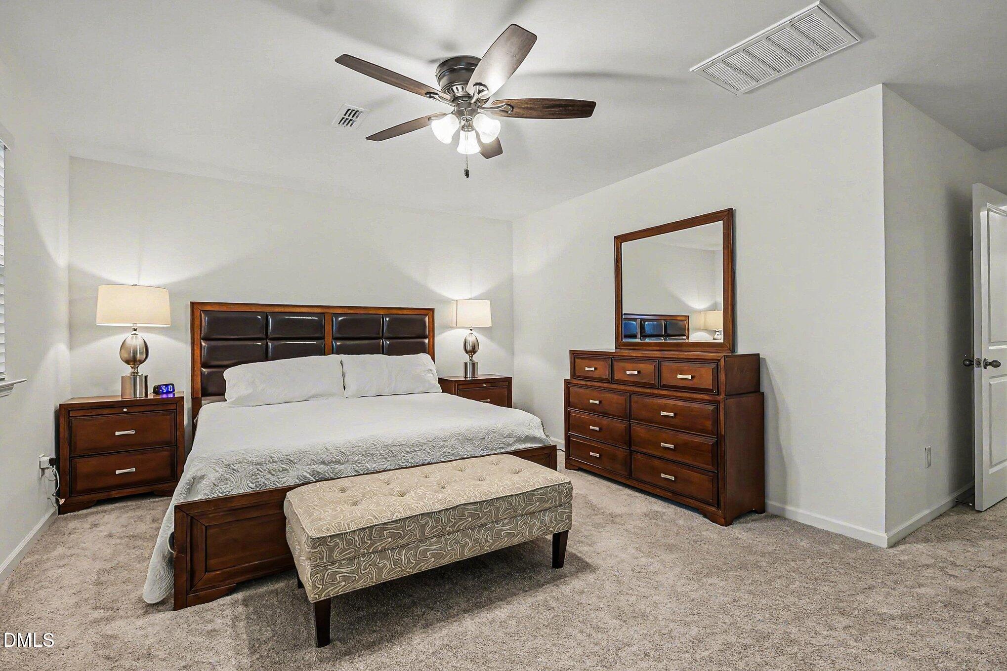 2732 Princess Tree Drive Raleigh, NC 27616 - Photo 13 of 32 a bedroom with a bed and a dresser