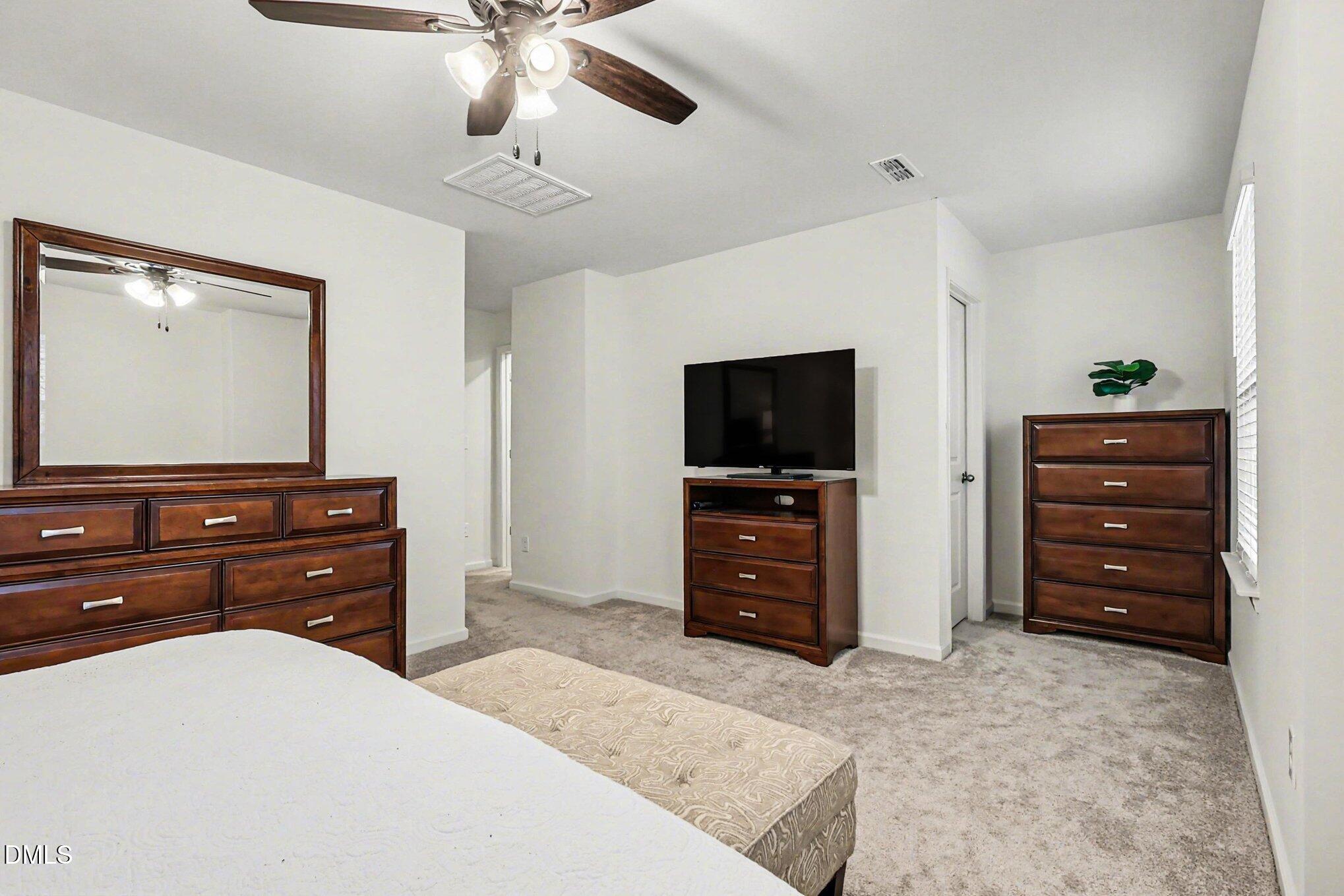 2732 Princess Tree Drive Raleigh, NC 27616 - Photo 14 of 32 a room with a dresser and a television