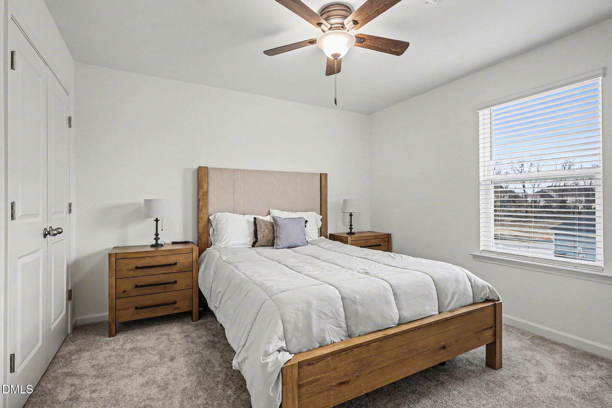 2732 Princess Tree Drive Raleigh, NC 27616 - Photo 17 of 32 a bedroom with a bed and a chandelier