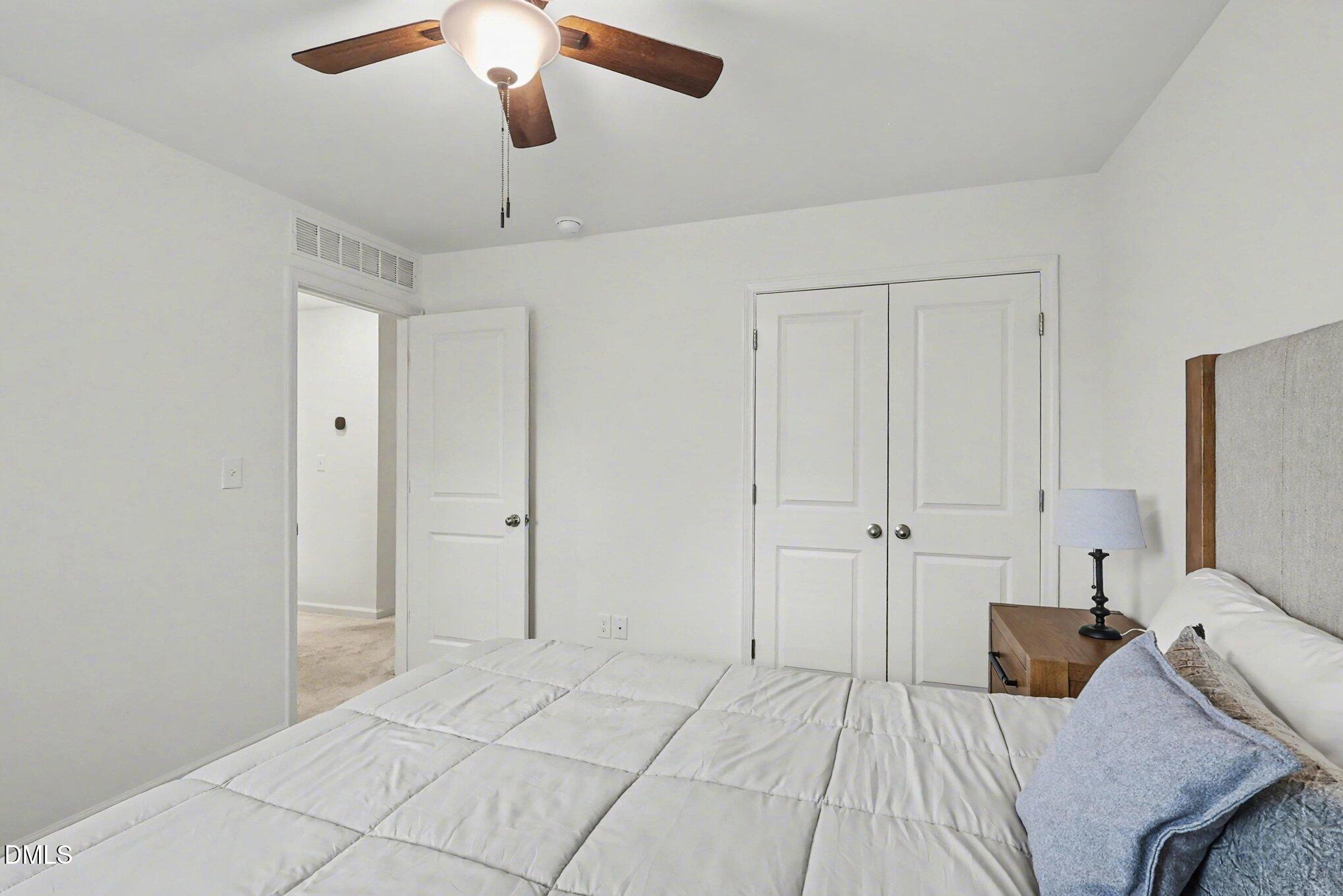2732 Princess Tree Drive Raleigh, NC 27616 - Photo 18 of 32 a bedroom with a bed and a chandelier