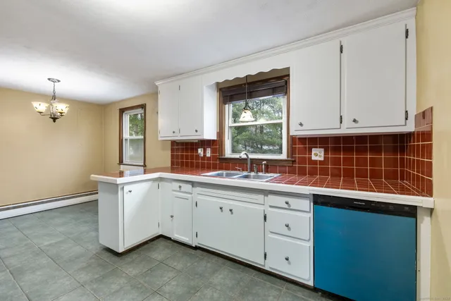 a kitchen with a refrigerator sink and cabinets