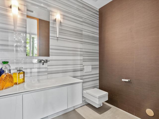 a kitchen with a stove a cabinets and chairs