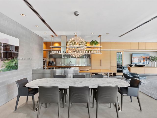 a living room with furniture and large windows