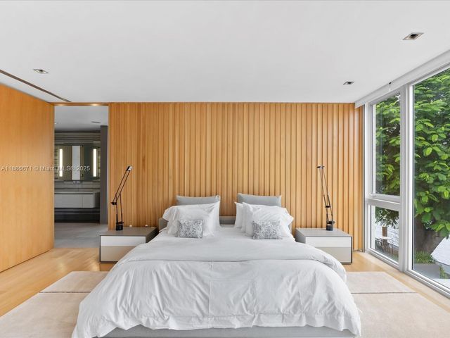 a bedroom with a bed and a night stand