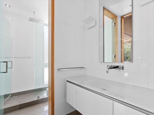 a view of swimming pool with lawn chairs and plants