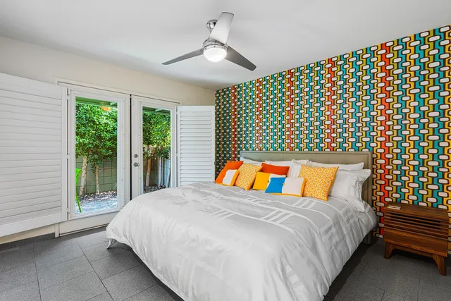 a bed sitting in a bedroom next to a window