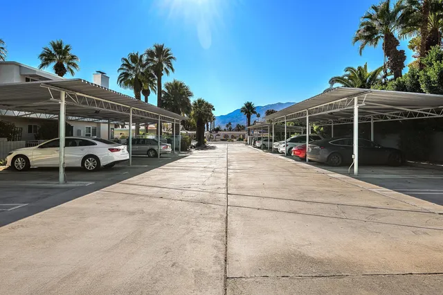 a view of a cars park in front of a building
