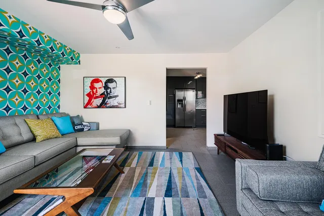 a living room with furniture and a flat screen tv