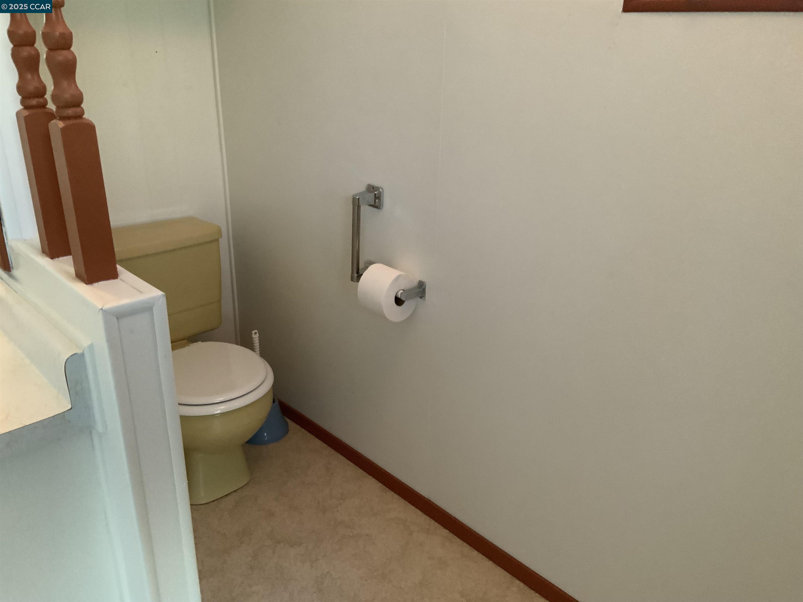 a white toilet sitting next to a shower