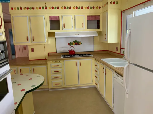 a kitchen with a sink stove and refrigerator