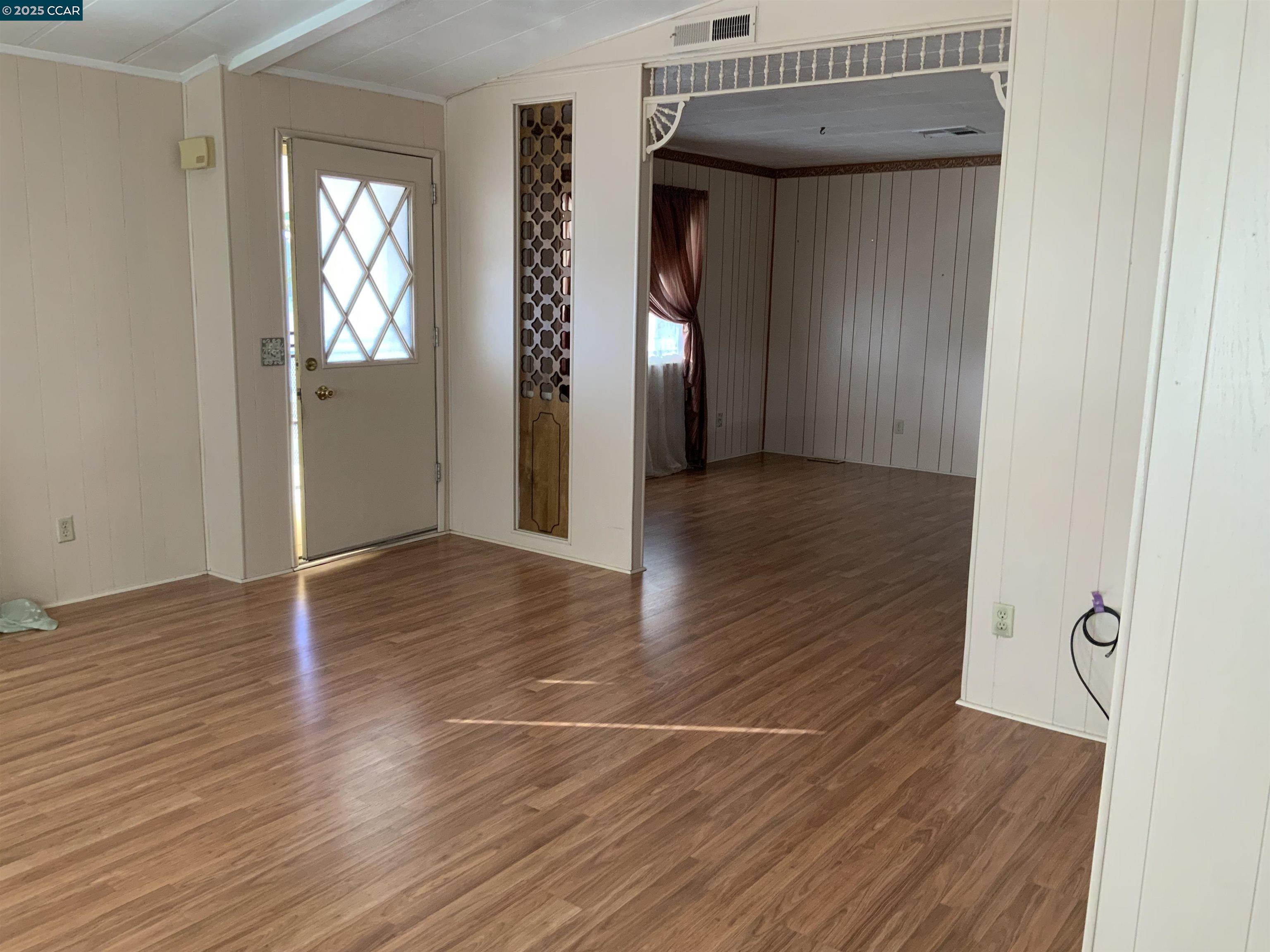 202 Queens Way Pittsburg, CA 94565 - Photo 18 of 29 an empty room with wooden floor and windows