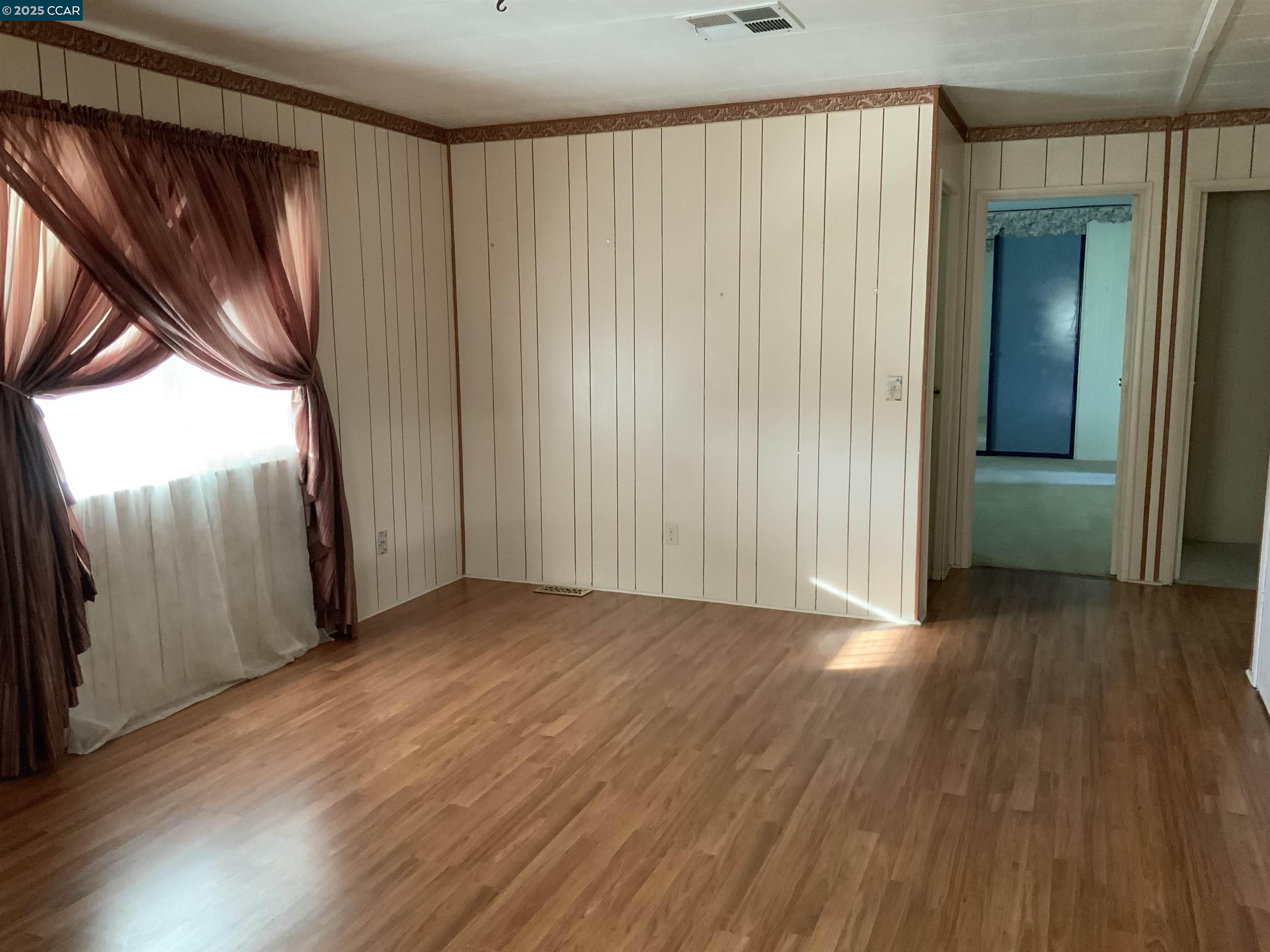 202 Queens Way Pittsburg, CA 94565 - Photo 19 of 29 a view of empty room with wooden floor and fan