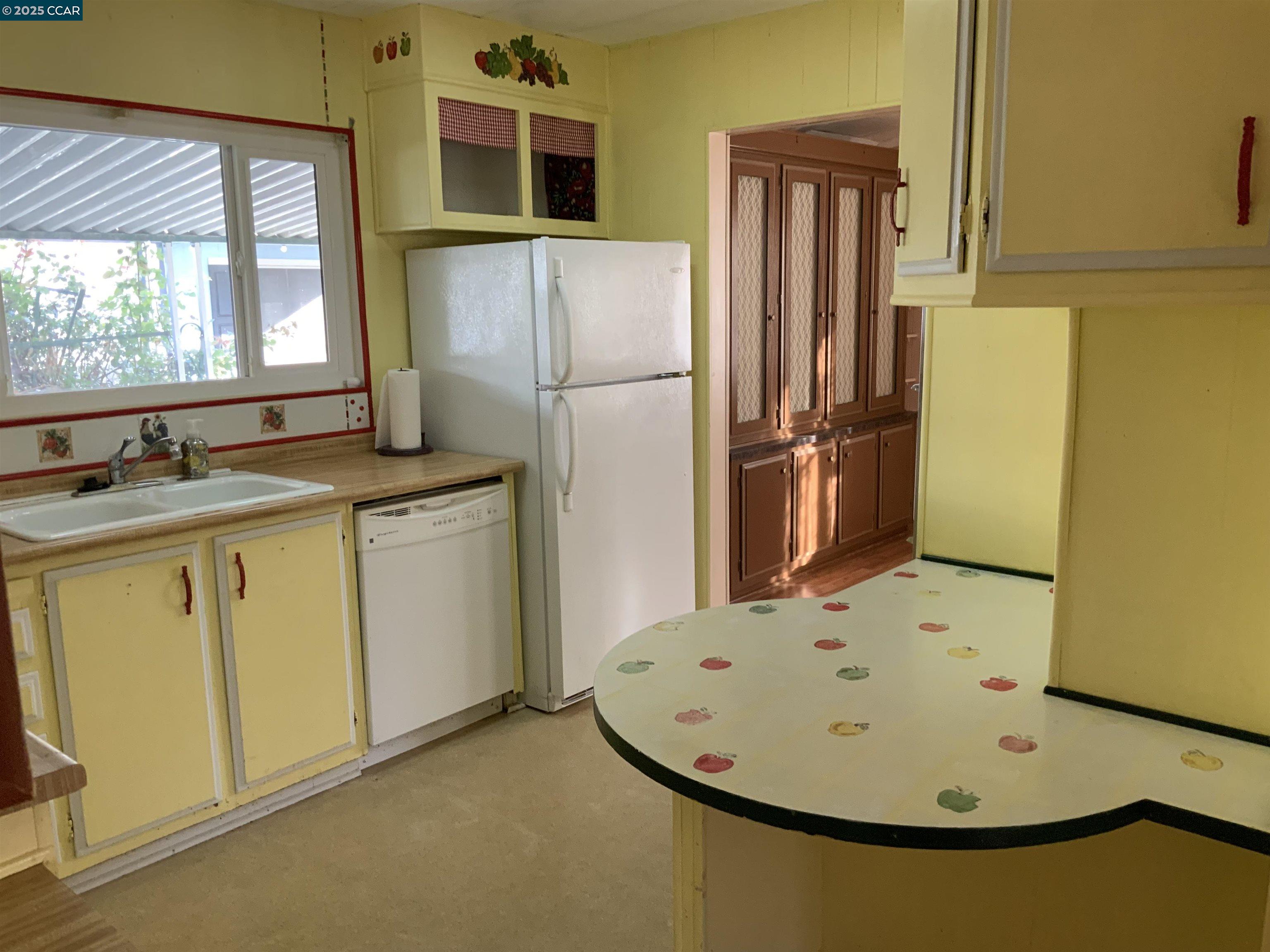 202 Queens Way Pittsburg, CA 94565 - Photo 23 of 29 a kitchen with a sink a refrigerator and window