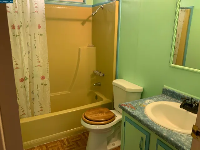 a bathroom with a granite countertop toilet sink and shower