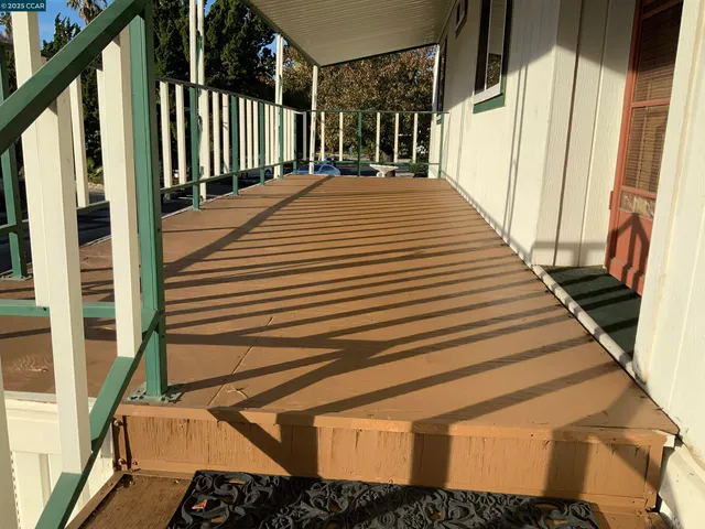 a view of a balcony with wooden floor