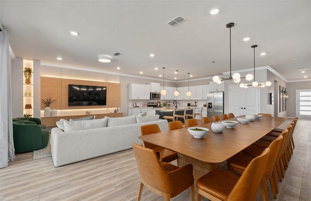 15918 Calm Key Loop Clermont, FL 34714 - Photo 16 of 57 a dining room with kitchen island a table and chairs