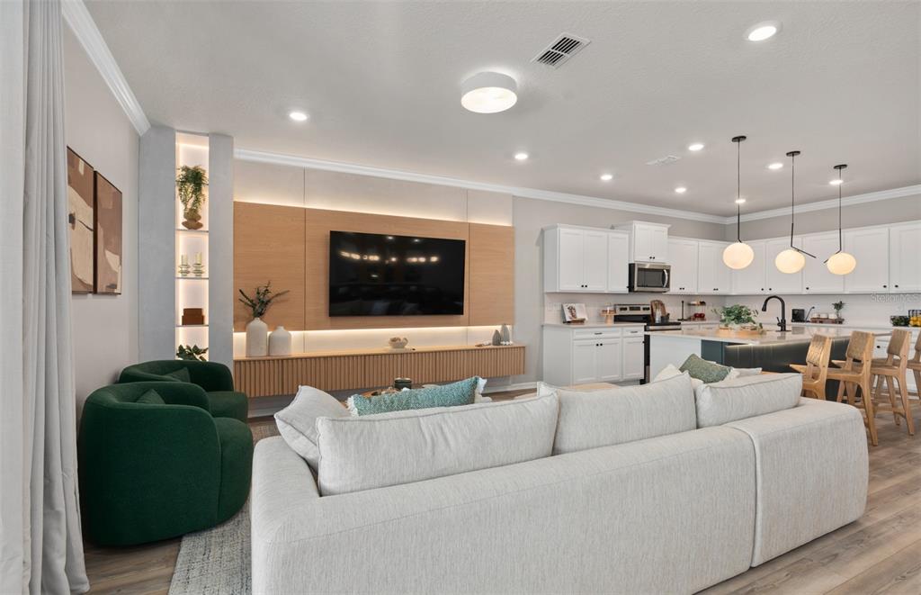 15918 Calm Key Loop Clermont, FL 34714 - Photo 17 of 57 a living room with furniture and a view of kitchen appliances