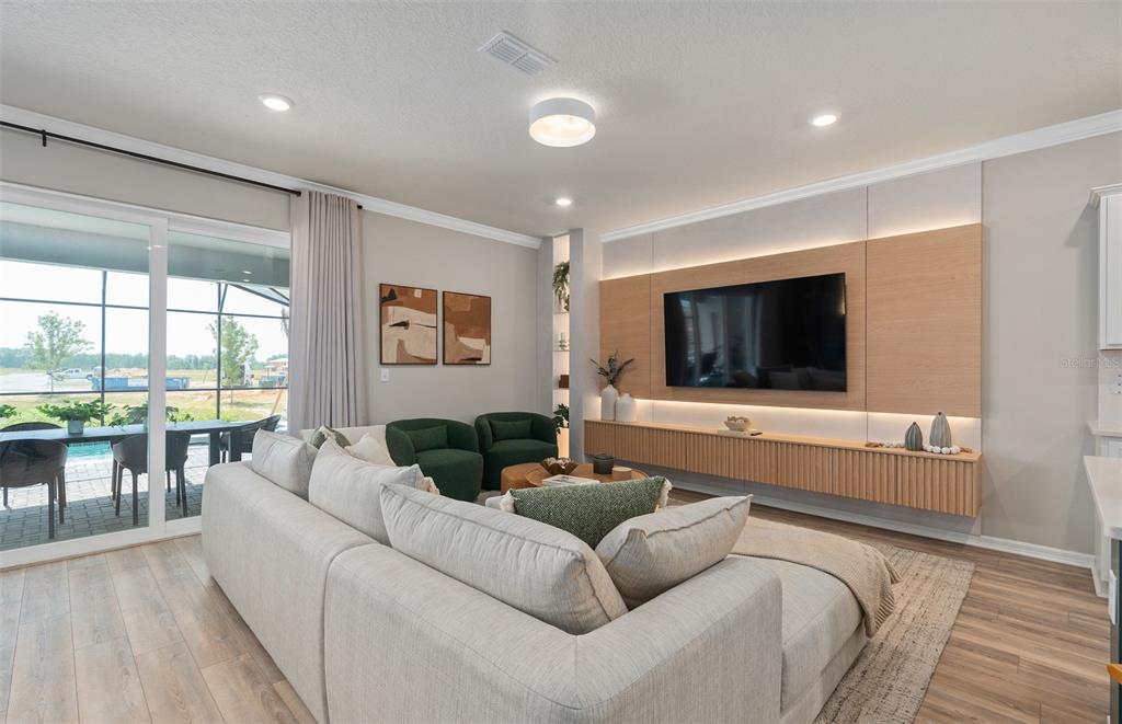 15918 Calm Key Loop Clermont, FL 34714 - Photo 18 of 57 a living room with furniture and a flat screen tv