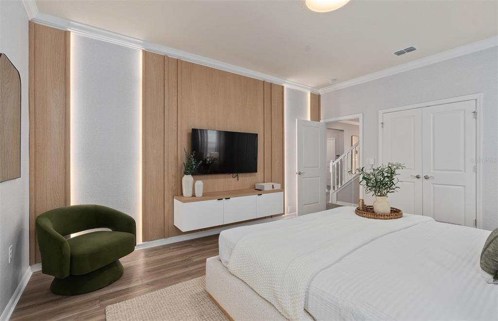 15918 Calm Key Loop Clermont, FL 34714 - Photo 24 of 57 a bedroom with a bed and a flat screen tv