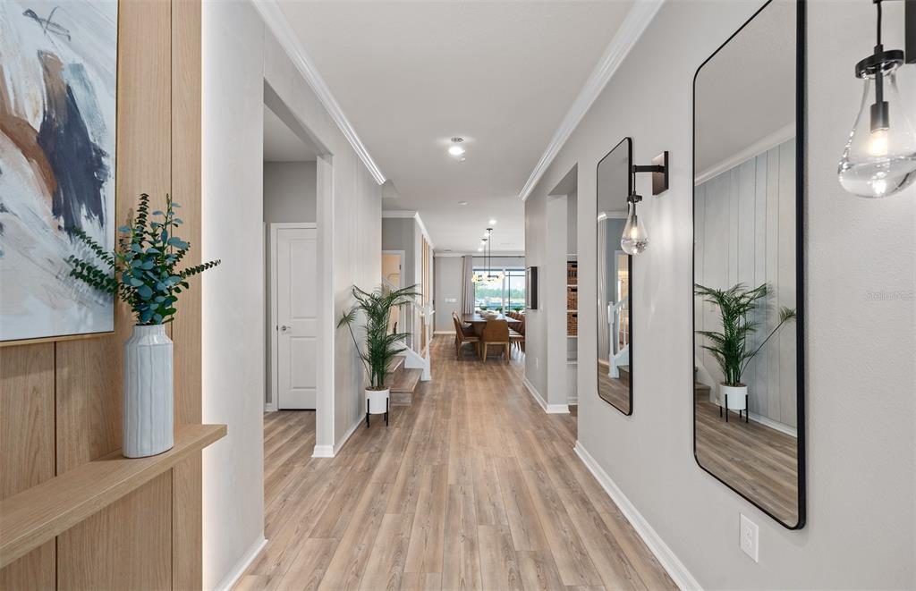 15918 Calm Key Loop Clermont, FL 34714 - Photo 3 of 57 a view of a hallway with wooden floor and a potted plant