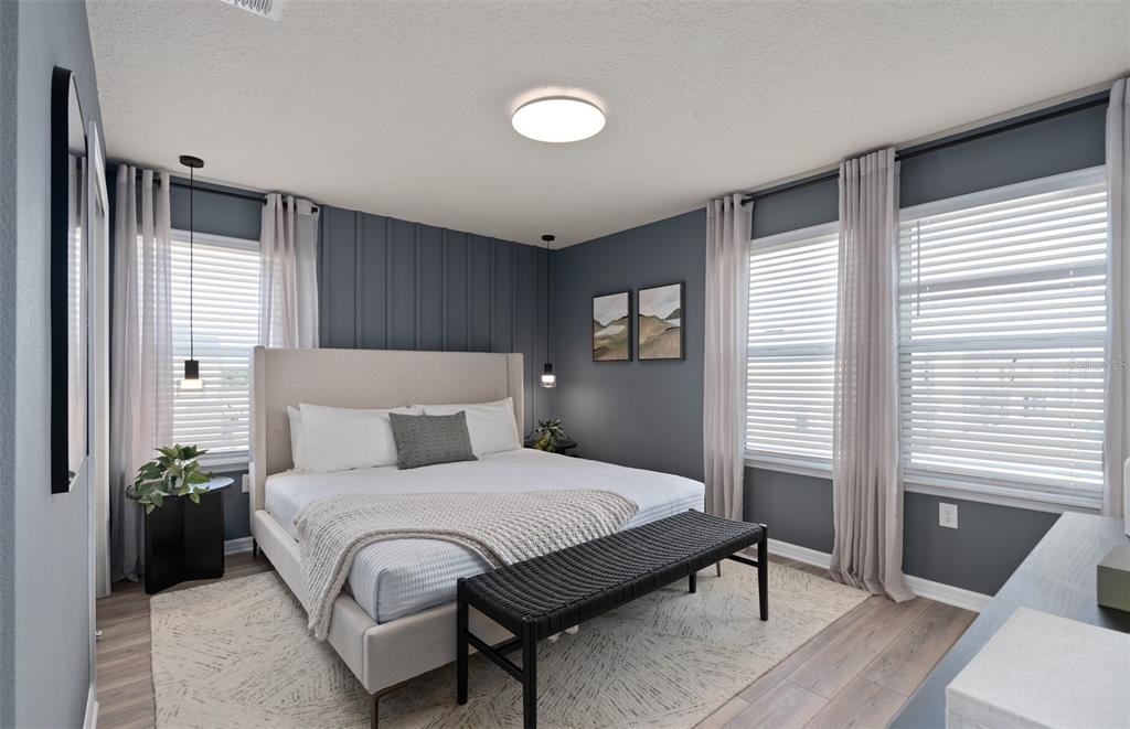 15918 Calm Key Loop Clermont, FL 34714 - Photo 35 of 57 a bedroom with a bed lamp and a large window