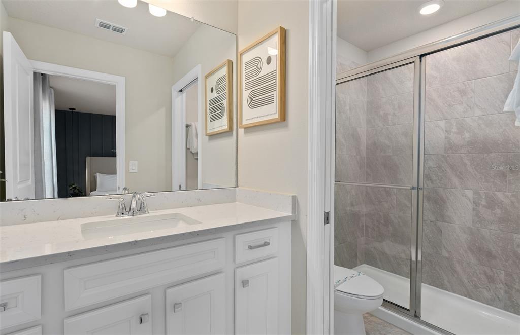 15918 Calm Key Loop Clermont, FL 34714 - Photo 37 of 57 a bathroom with a sink toilet and shower