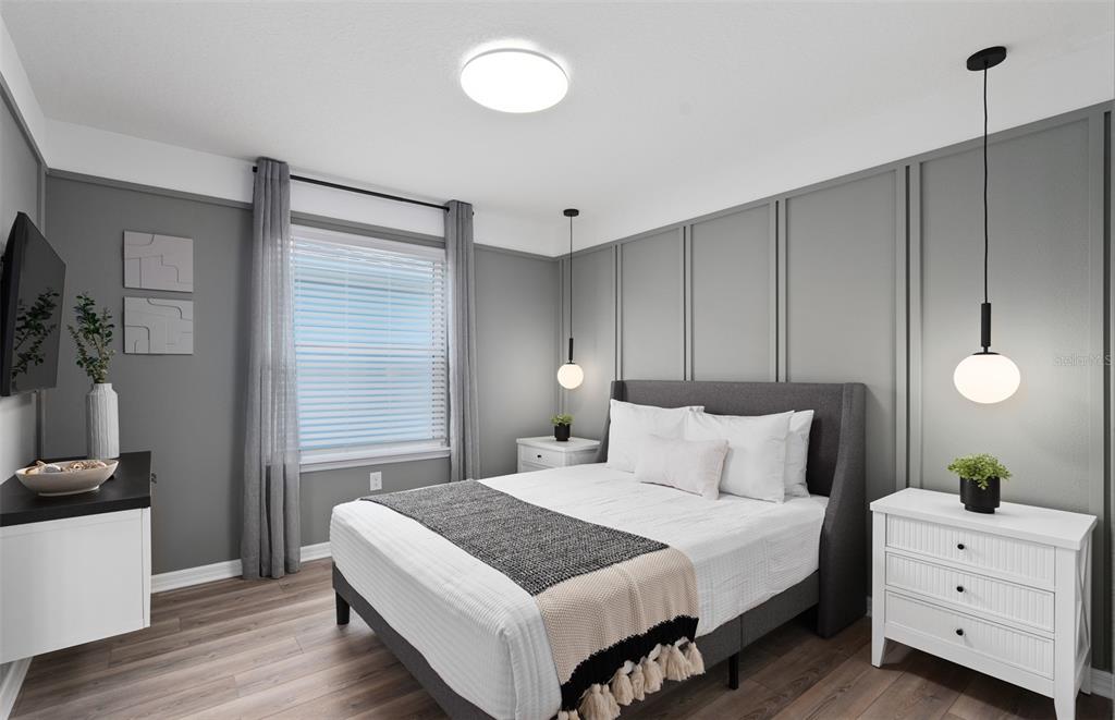 15918 Calm Key Loop Clermont, FL 34714 - Photo 42 of 57 a bedroom with a bed and a flat tv screen on dresser