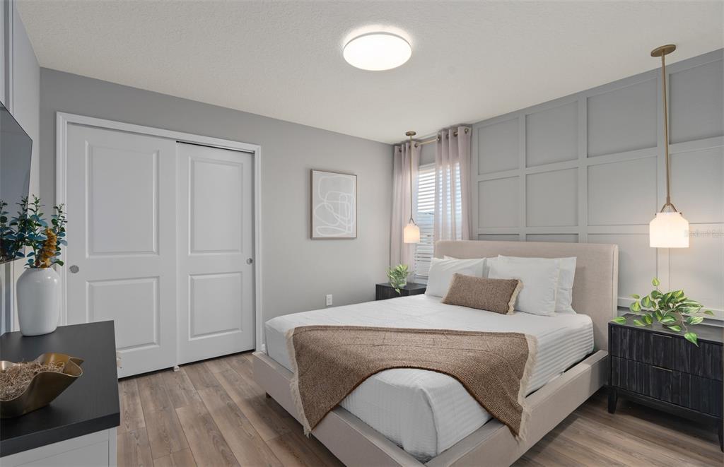 15918 Calm Key Loop Clermont, FL 34714 - Photo 47 of 57 a bedroom with a bed and a potted plant