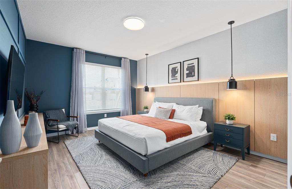 15918 Calm Key Loop Clermont, FL 34714 - Photo 5 of 57 a bedroom with a large bed and a large window