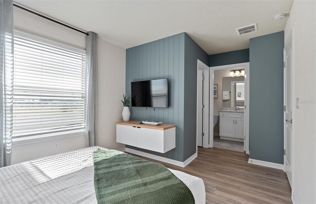 15918 Calm Key Loop Clermont, FL 34714 - Photo 53 of 57 a bedroom with a bed and a flat screen tv