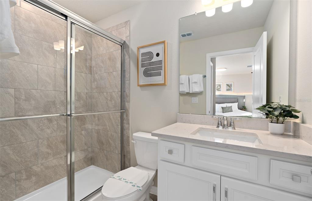 15918 Calm Key Loop Clermont, FL 34714 - Photo 54 of 57 a bathroom with a sink toilet and shower