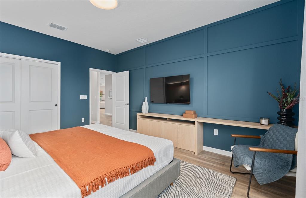 15918 Calm Key Loop Clermont, FL 34714 - Photo 6 of 57 a bedroom with a bed and a flat screen tv