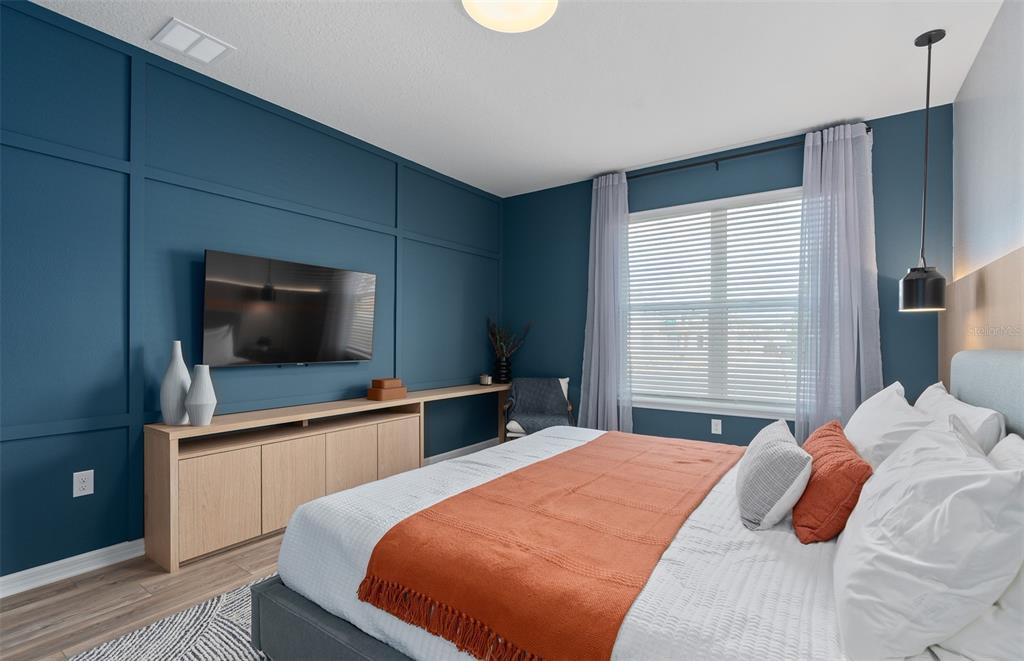 15918 Calm Key Loop Clermont, FL 34714 - Photo 7 of 57 a bedroom with a bed and a flat screen tv