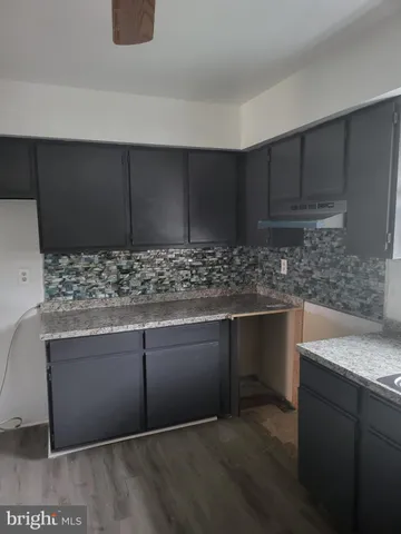 a kitchen with granite countertop cabinets and sink