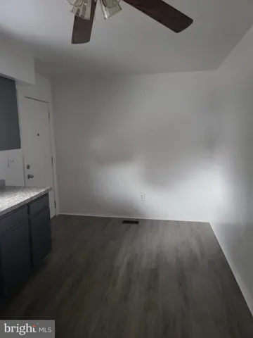 a view of an empty room and wooden floor