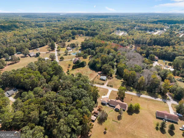 an aerial view of a house with a yard