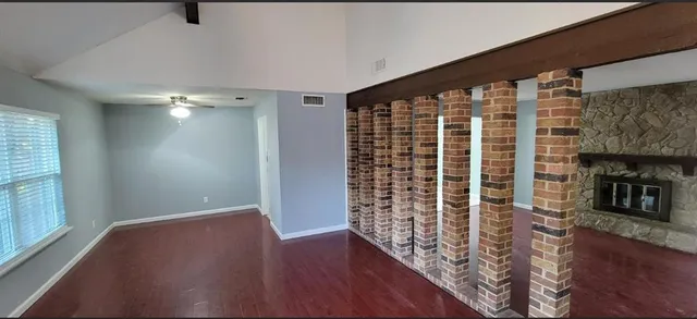 wooden floor in an empty room with a window