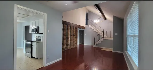 a view of entryway with wooden floor and stairs