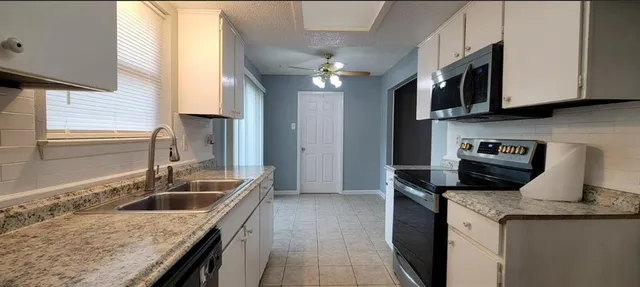 a kitchen that has a sink and a stove