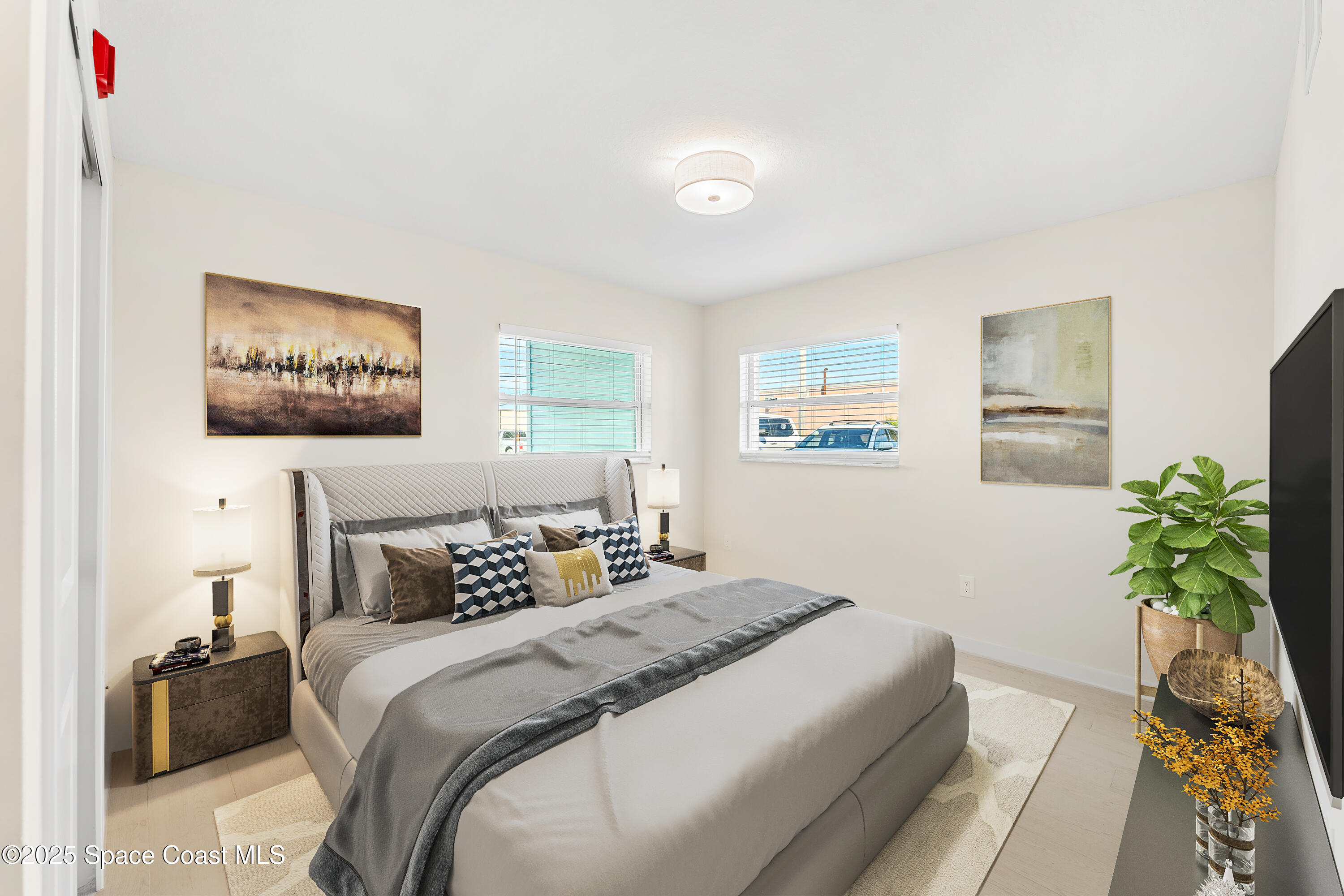 122 Central Road, Unit 101 Indian Harbour Beach, FL 32937 - Photo 5 of 14 a bedroom with a large bed and a couch