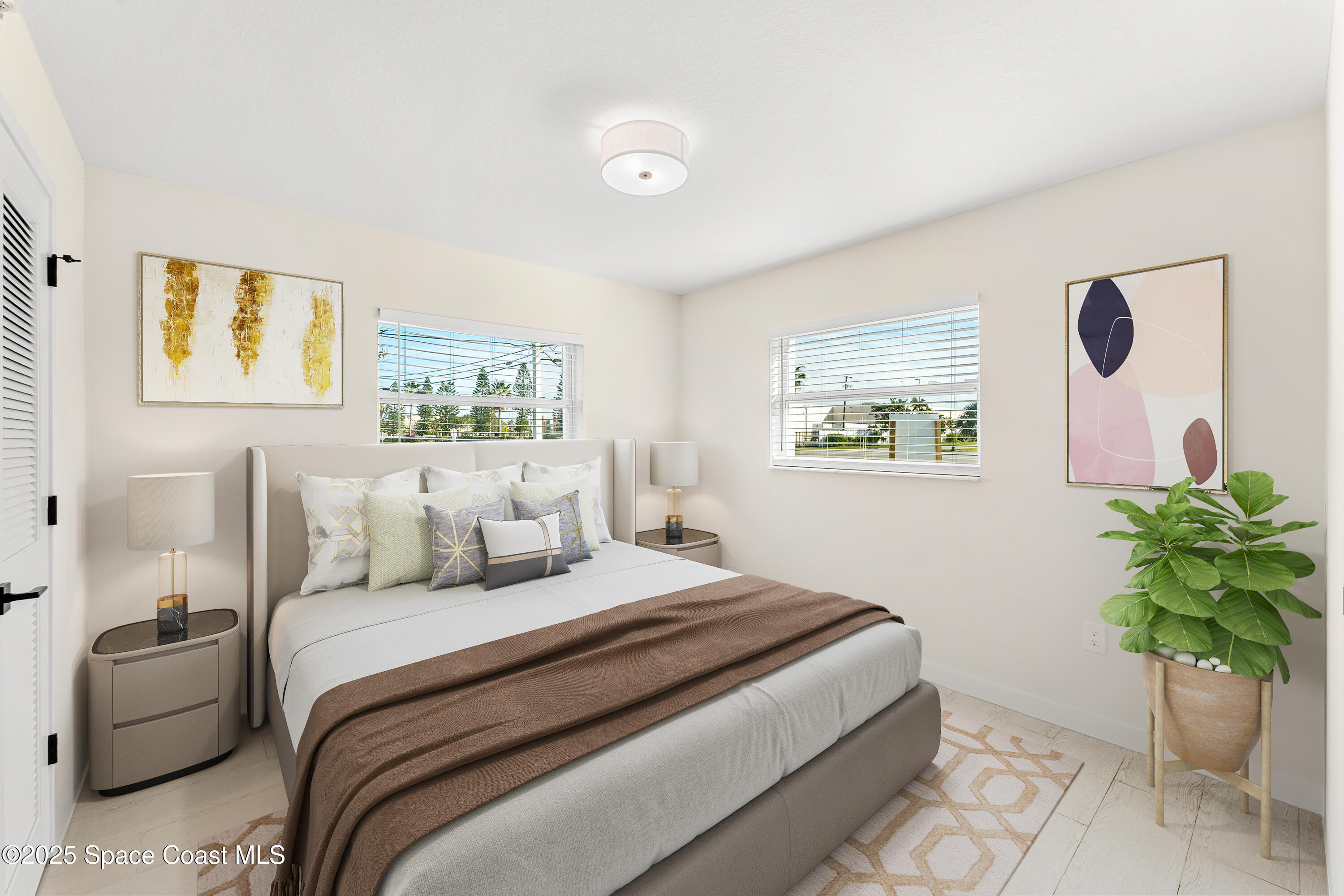 122 Central Road, Unit 101 Indian Harbour Beach, FL 32937 - Photo 6 of 14 a bedroom with a bed and a plant