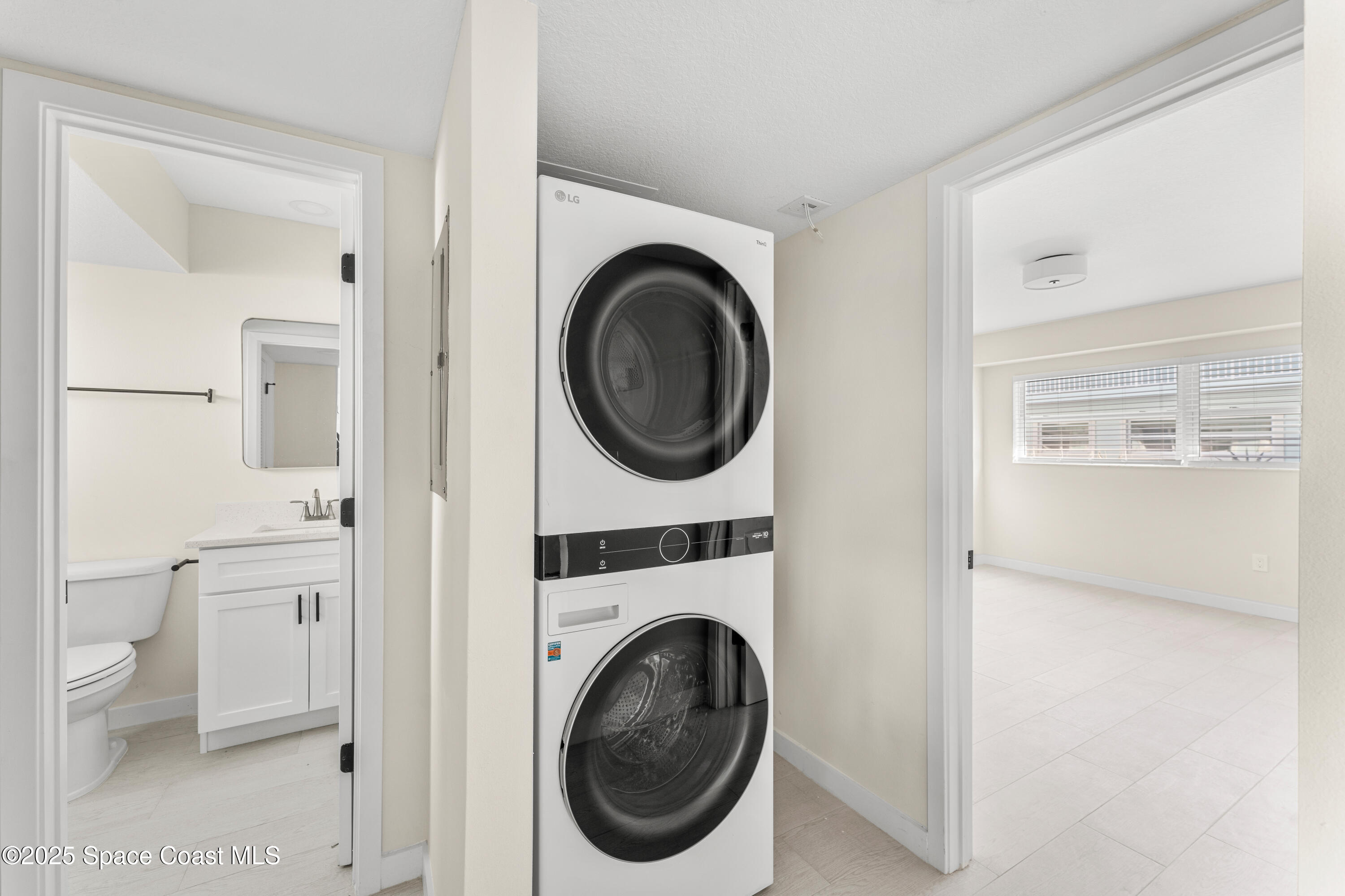 122 Central Road, Unit 101 Indian Harbour Beach, FL 32937 - Photo 8 of 14 a utility room with sink dryer and washer