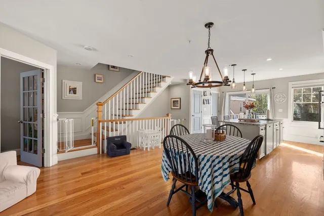 a dining room with furniture wooden floor and a chandelier