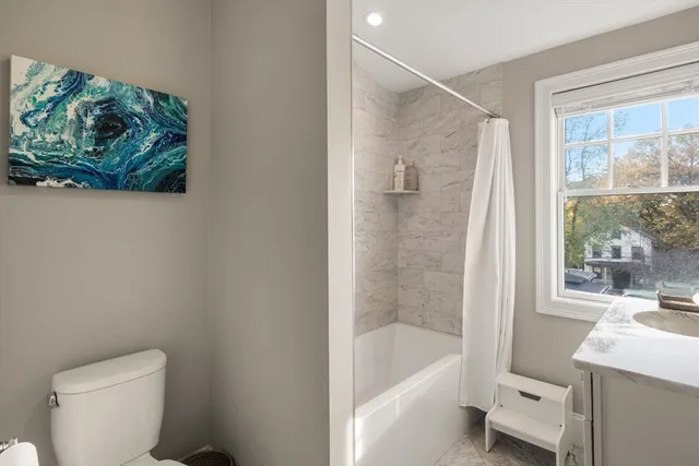 a bath room with a toilet and a bath tub