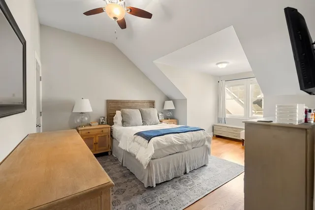 a bedroom with bed and a large window