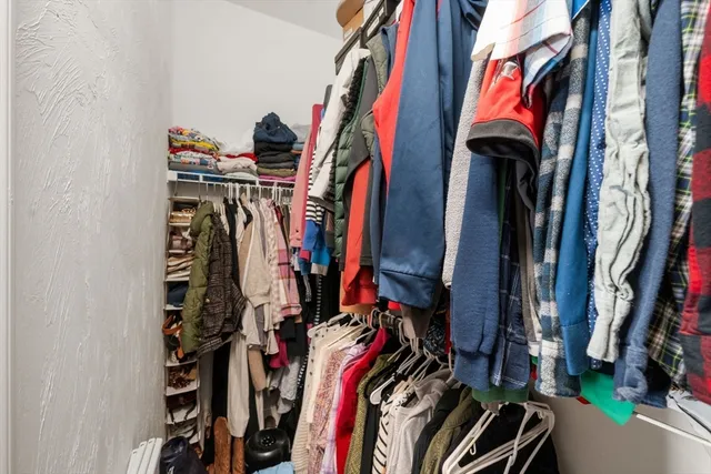 a view of walk in closet with clothes