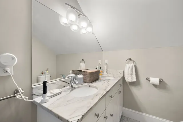 a bathroom with a double vanity sink and a mirror