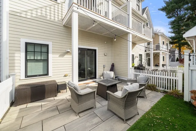 a view of a patio with couches table and chairs and potted plants
