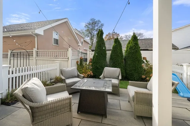 a view of a patio with couches chairs and wooden floor