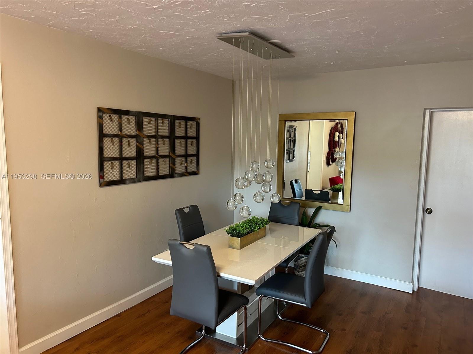 262 Southwest 54th Avenue Plantation, FL 33317 - Photo 11 of 16 a view of a dining room with furniture and wooden floor